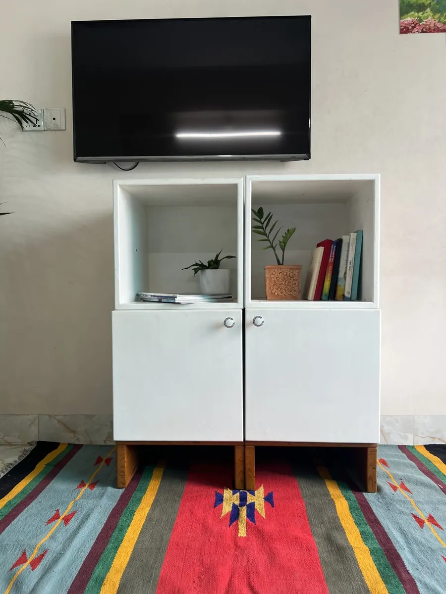 A Briddhi cabinet with a bookshelf above