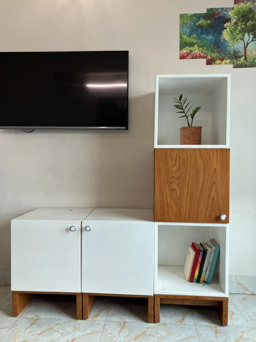 A Briddhi set mixing white and teak finishes