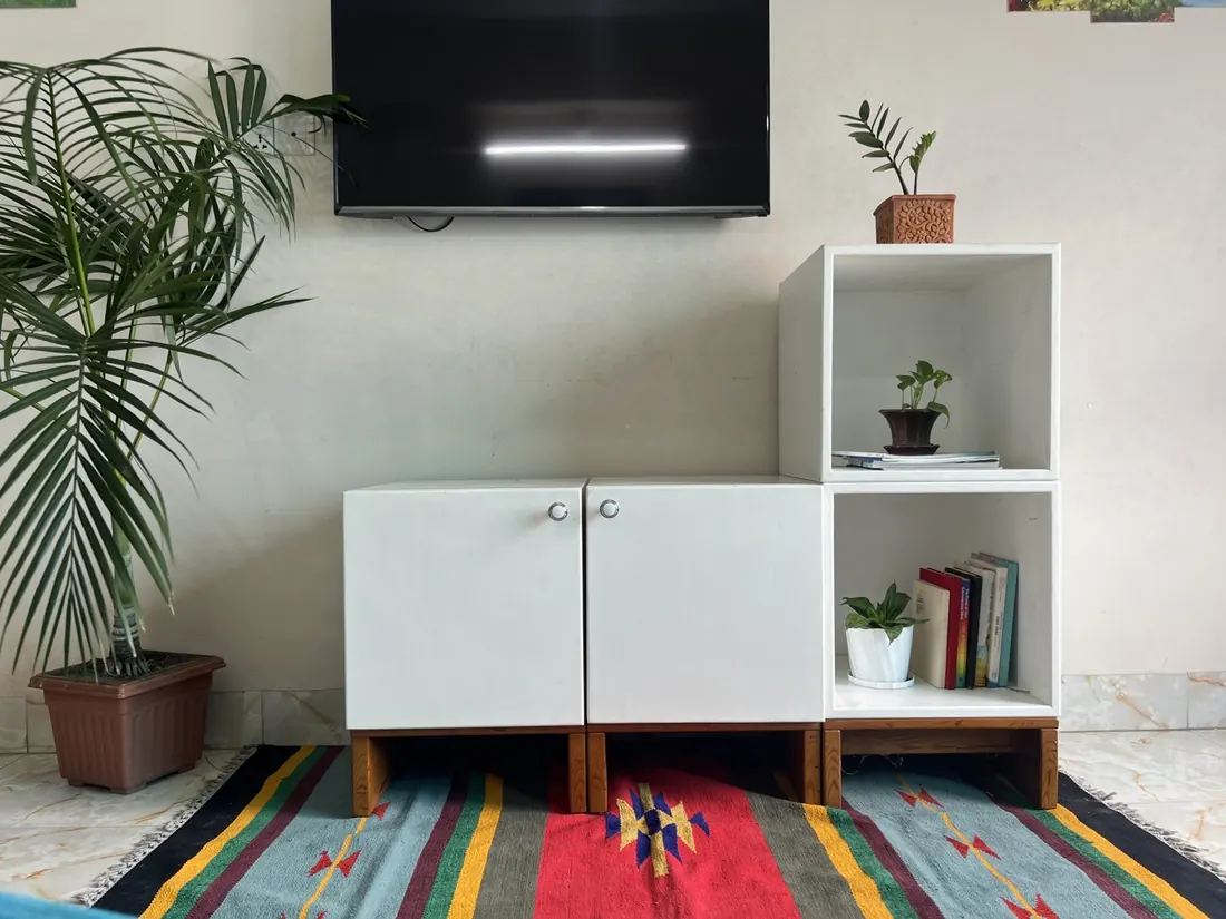 A white Briddhi sideboard with an open cube in a home